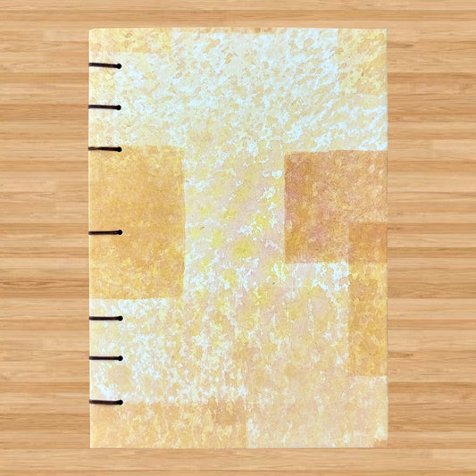 Blocked Orange - A6 - Lined - Coptic Bound - Fountain Pen Notebook - Handmade Journal with an abstract orange and cream cover and visible black coptic stitching