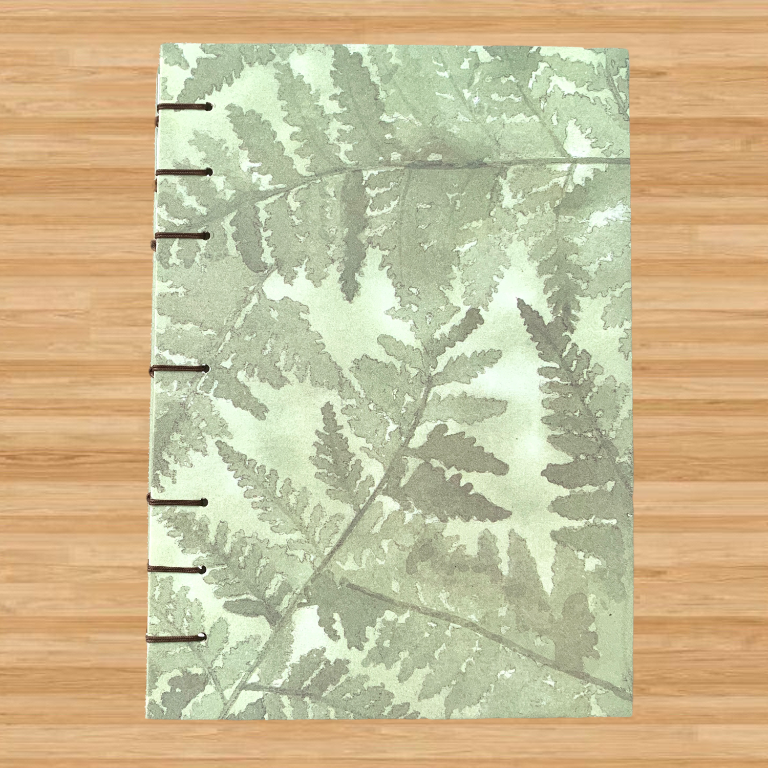 Green fern plant handmade coptic-bound journal with dot grid paper inside that is fountain pen-friendly!