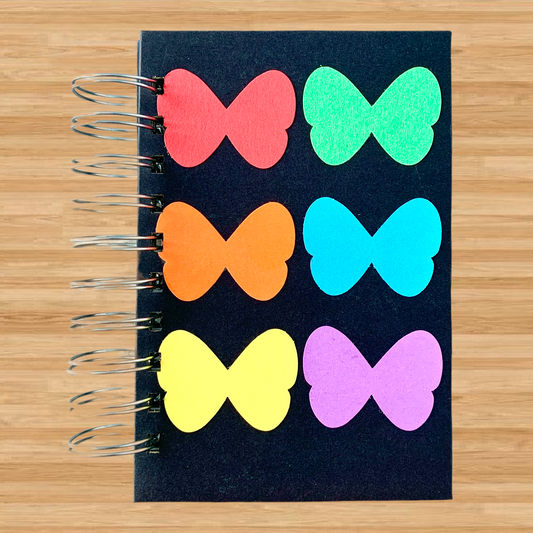 Rainbow butterflies on a handmade spiral-bound journal. Lined pages and fountain pen-friendly!